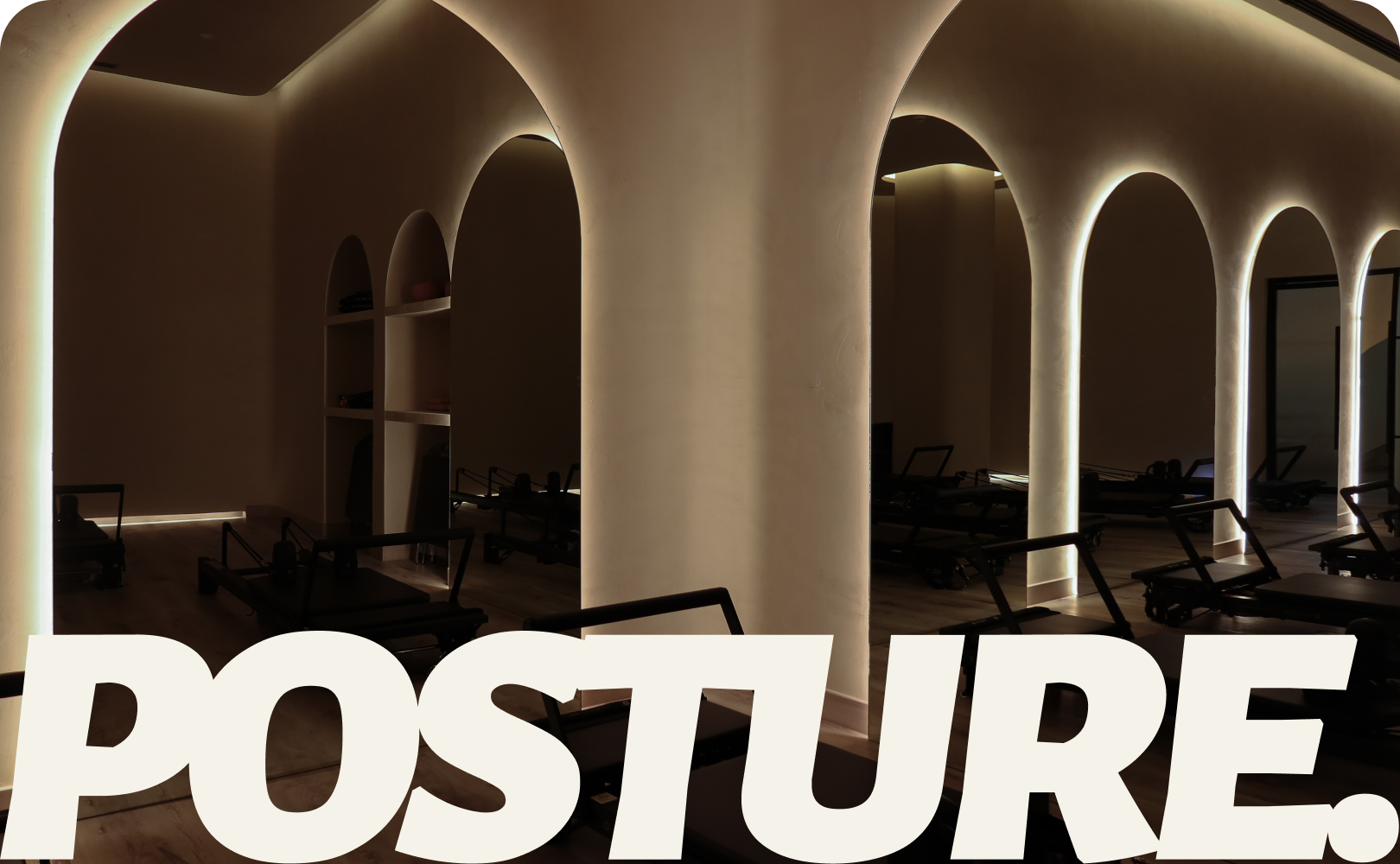 Posture Pilates Studio Interior – Arched Lighting and Reformer Room, The Palm Dubai Warmly lit pilates studio with sculptural arches and multiple reformer machines, showcasing Posture Pilates interior design and brand identity in The Palm, Dubai