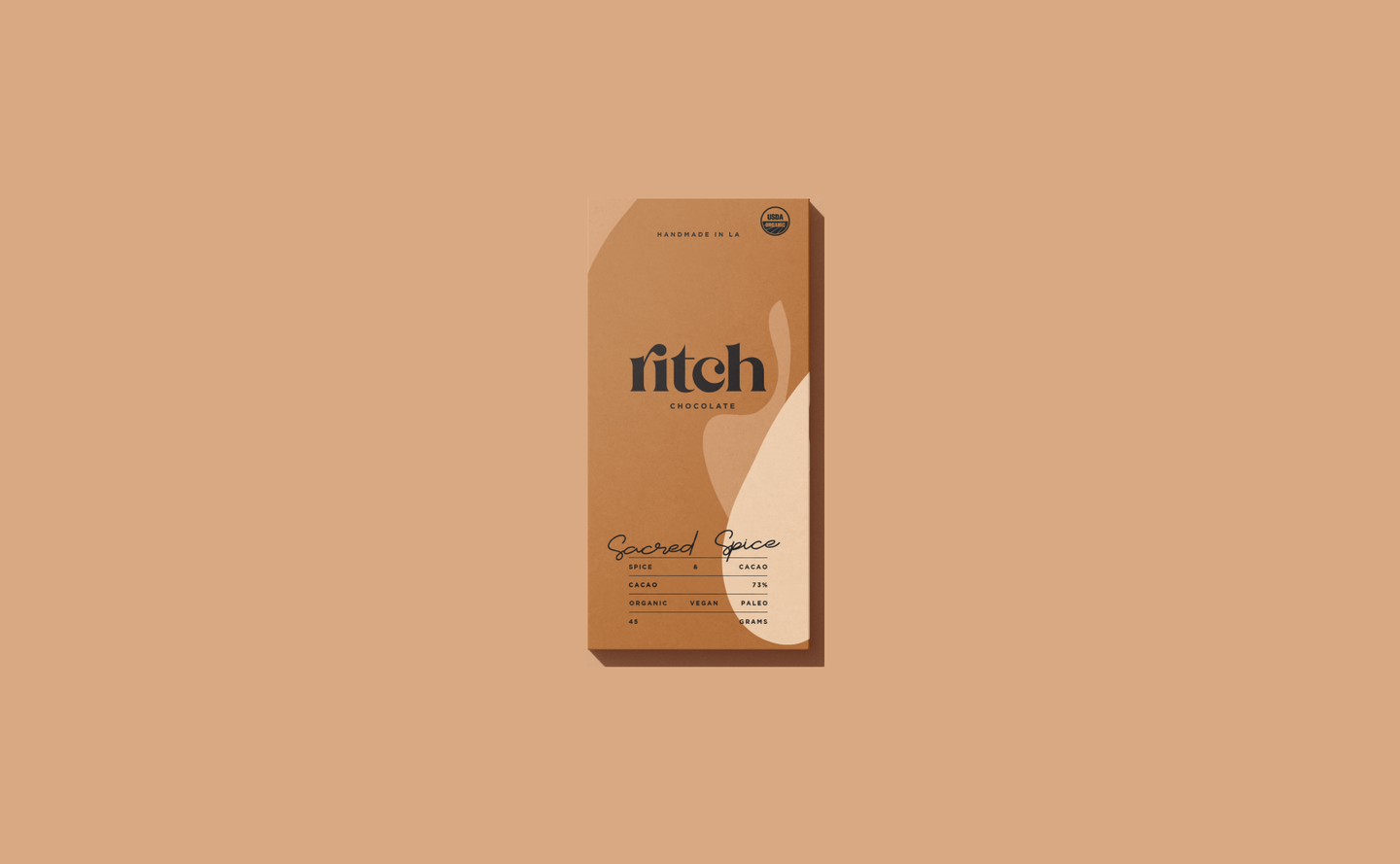 Ritch Handmade Chocolate – Sacred Spice Packaging Design by eeze studio Elegant packaging for Ritch Handmade Chocolate’s Sacred Spice flavor, showcasing minimalist branding and subtle curves.