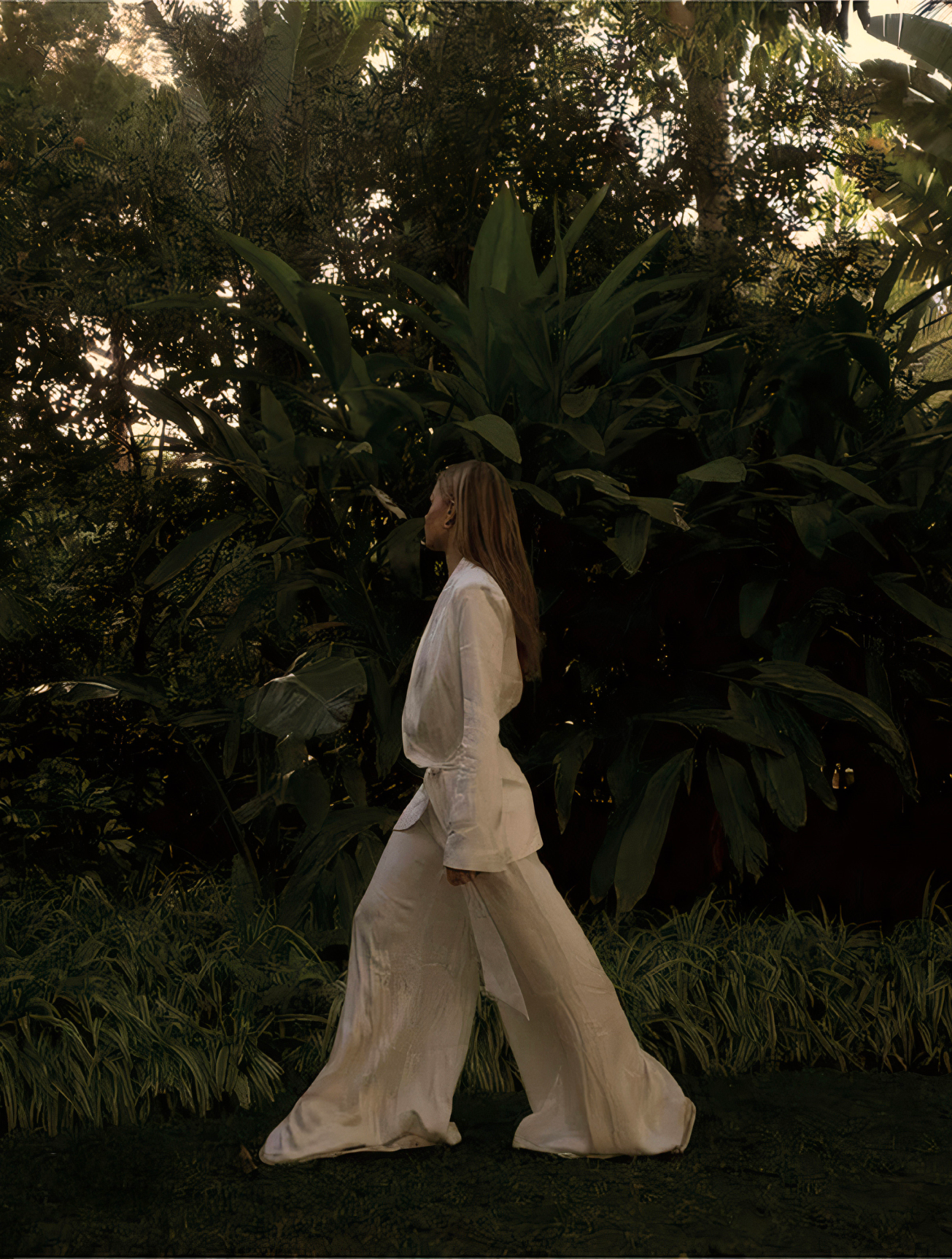 OREUM Lifestyle Editorial—Minimal Resort Fashion Branding by Eeze Studio Editorial photograph for OREUM highlighting a model in minimalist resort attire, walking through lush tropical gardens; branding and visual direction by Eeze Studio for luxury Bali hospitality and lifestyle ventures.