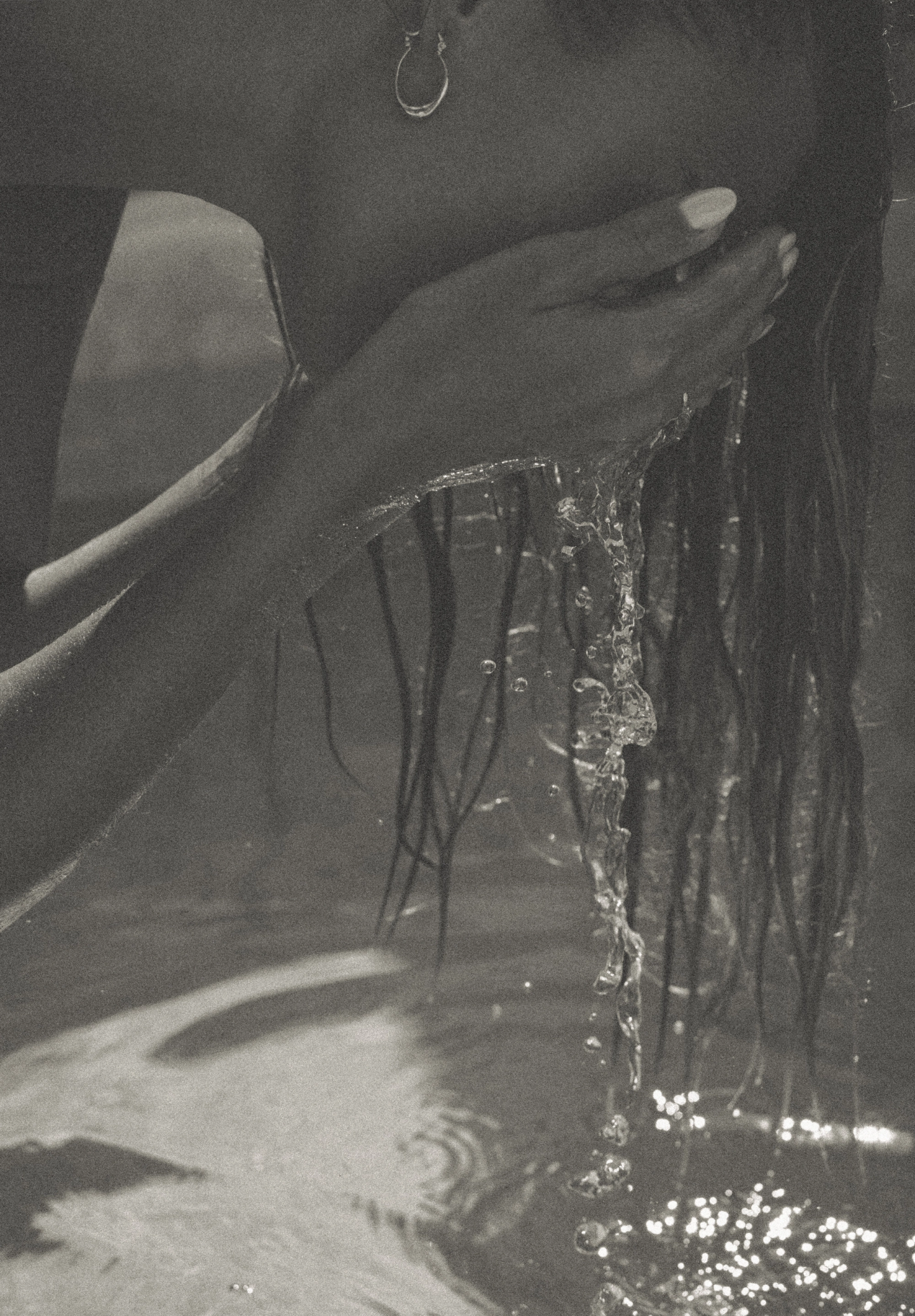 Monochrome close-up of a spa guest’s ear adorned with jewelry, highlighting the refined, intimate experience and branding for MAJA Bali boutique hotel and spa