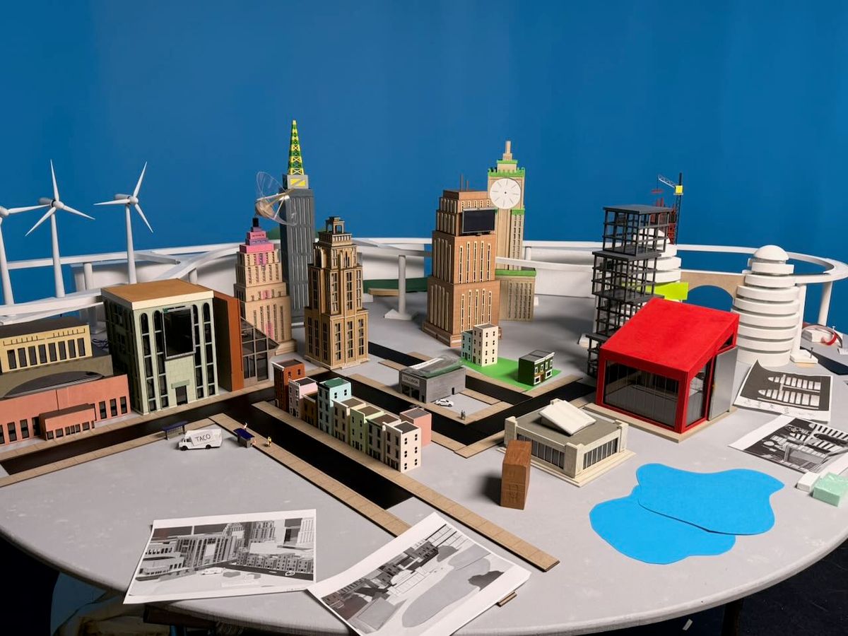 The Stripe City model on set, buildings and miniature details visible against a blue chroma key background