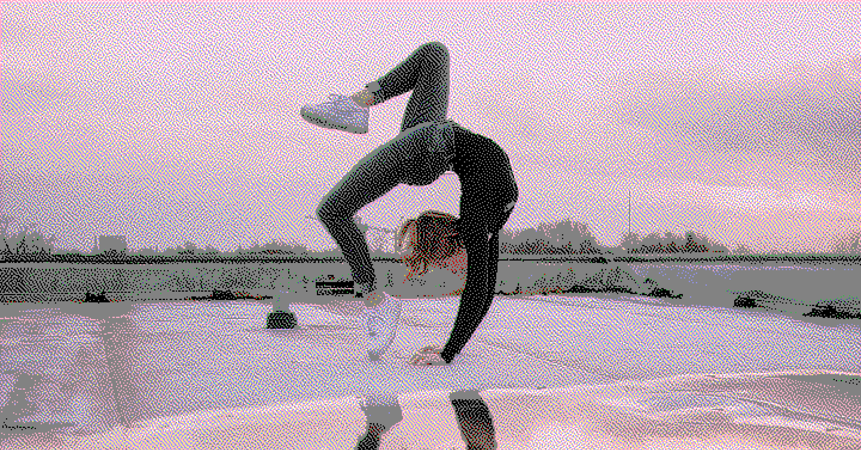 Female dancer doing an extreme back bend on a rooftop