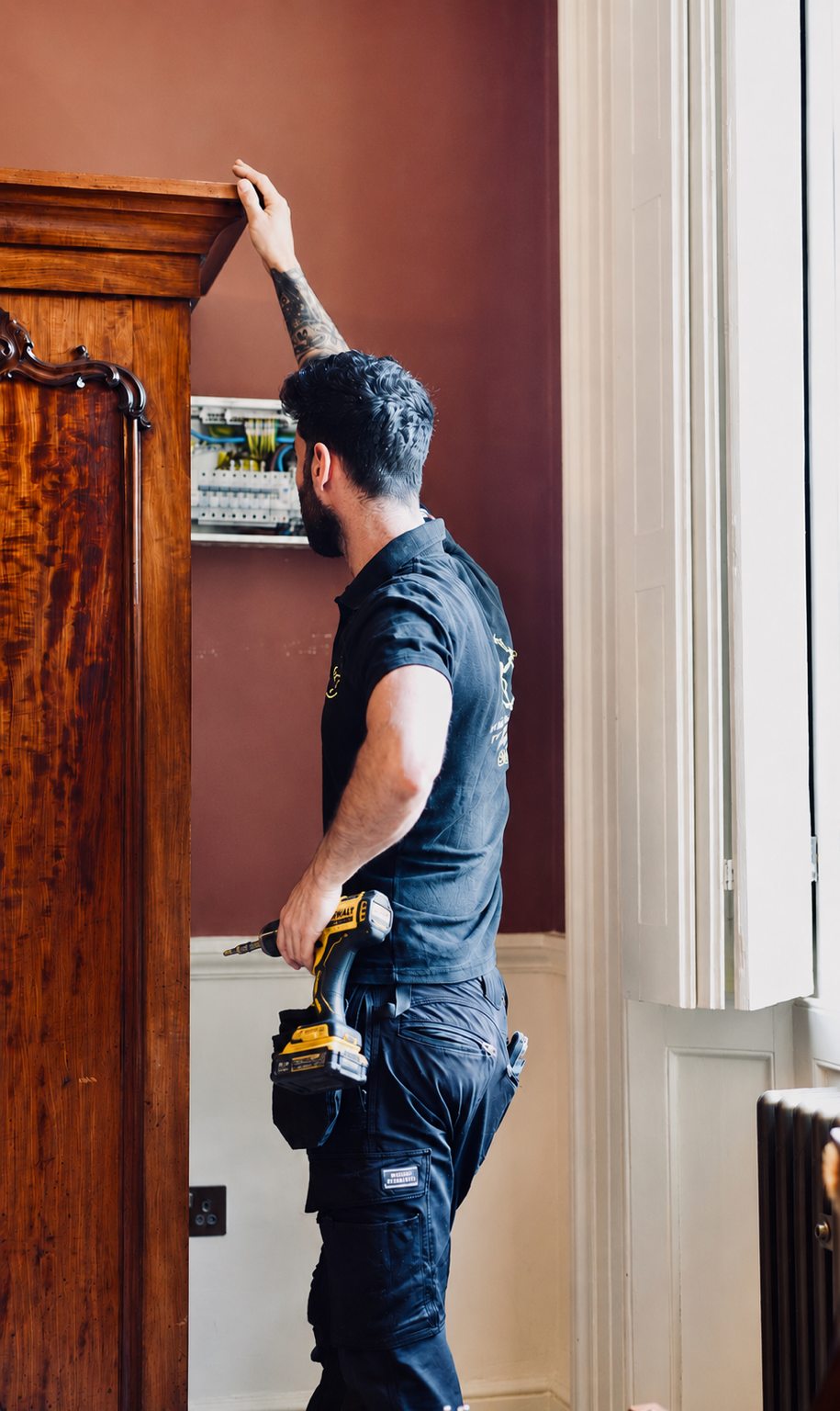 Professional qualified electrician carrying out electrical work in London