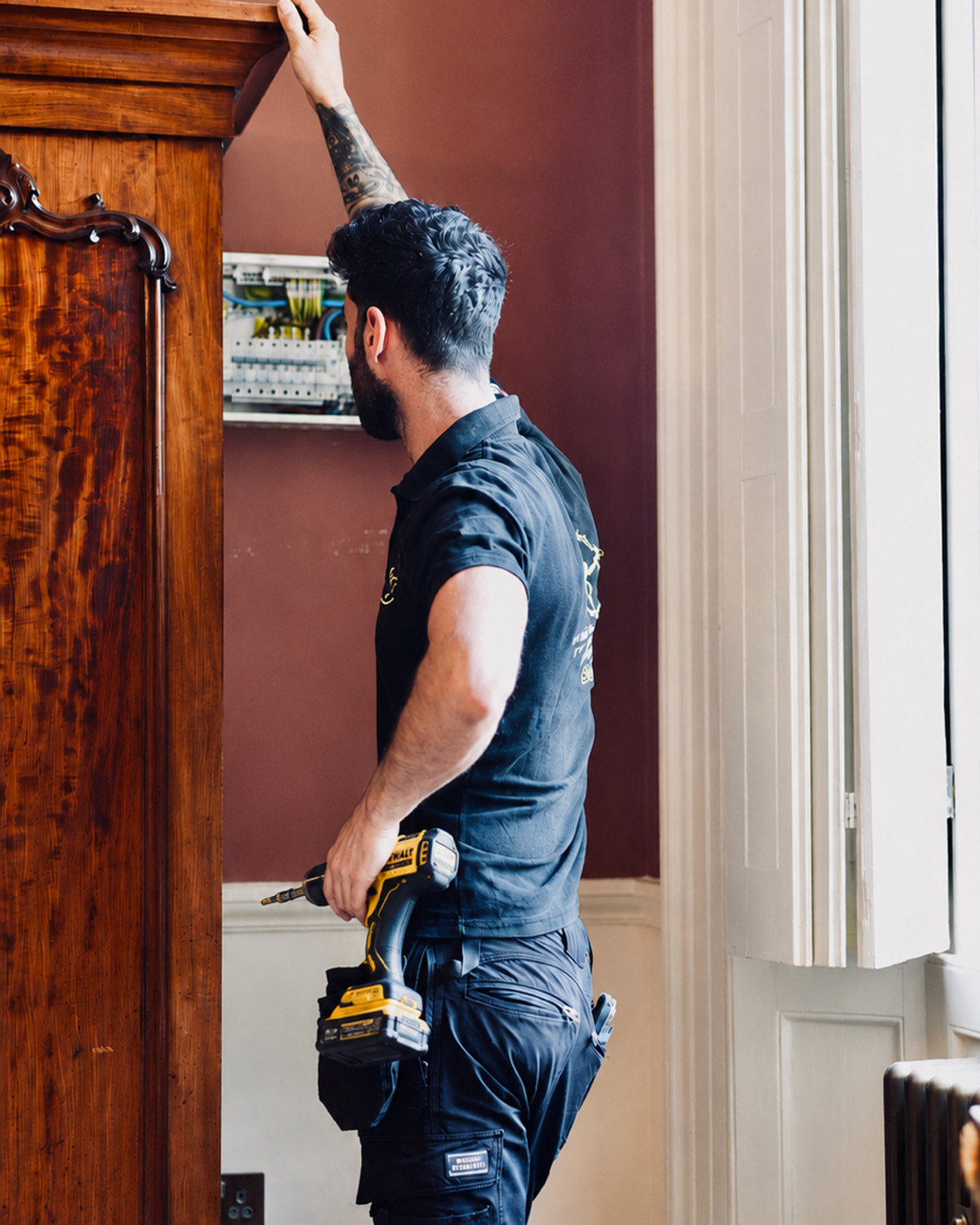 Professional qualified electrician carrying out electrical work in London