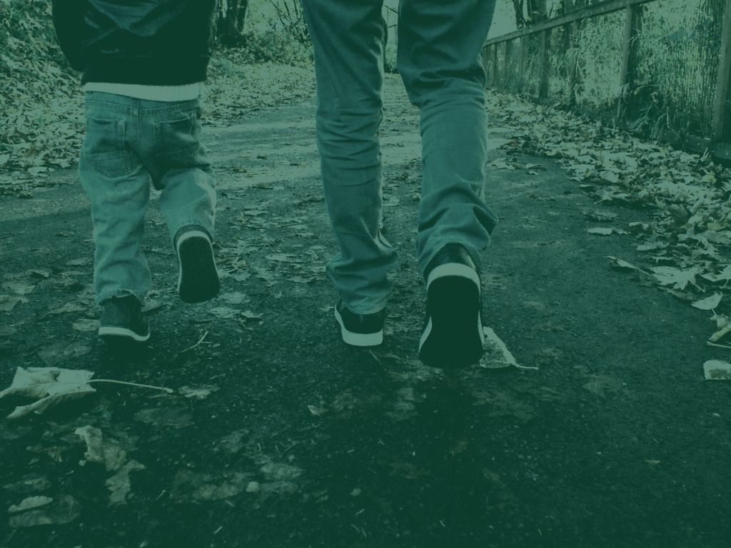 Adult and child walking on trail