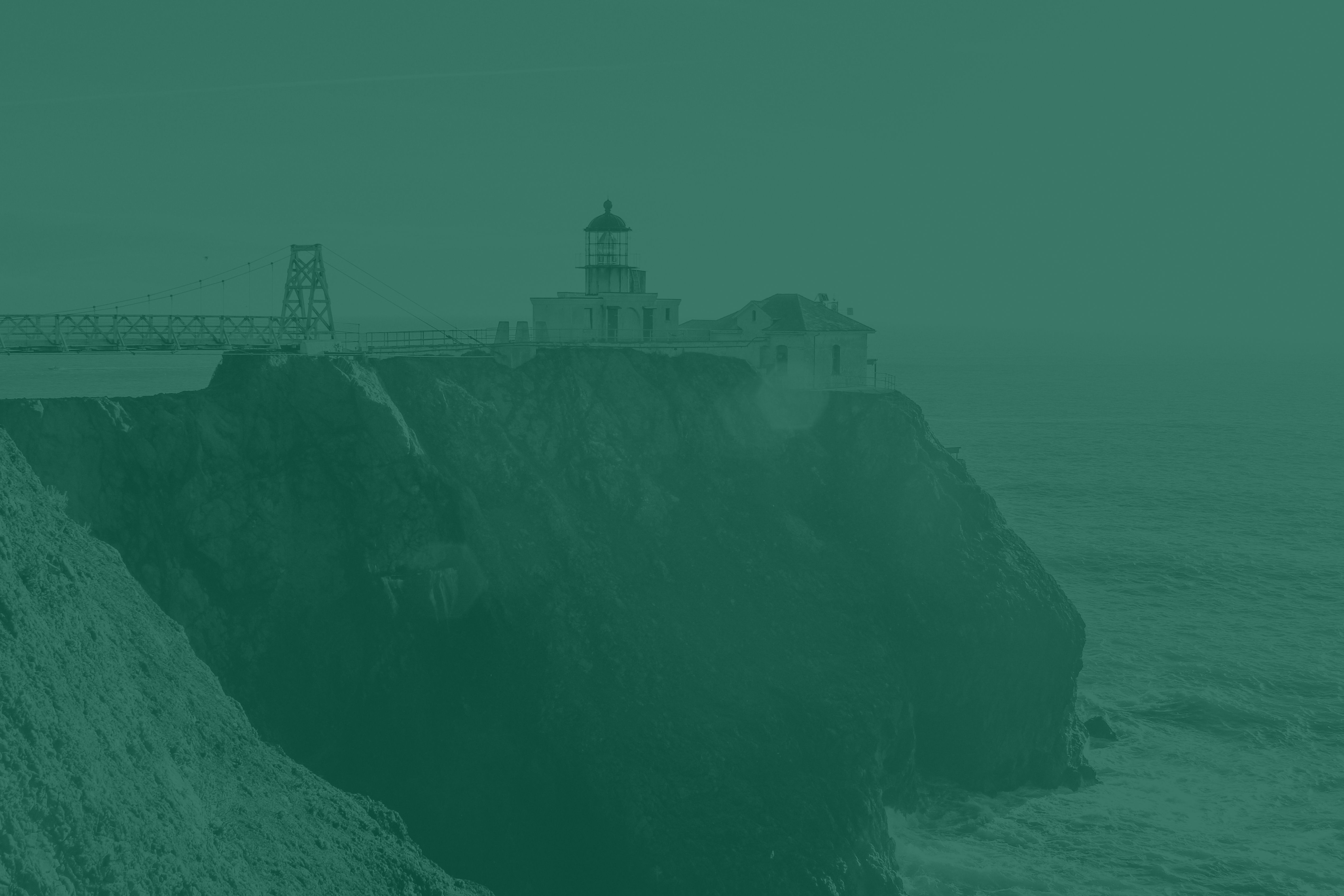 A lighthouse on a cliff overlooking the ocean.