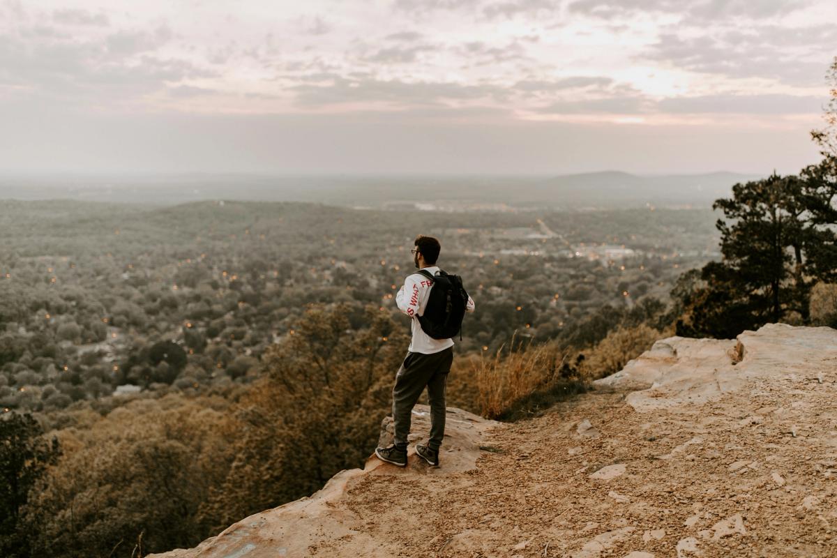 Man stood on a precipice, considering everything.