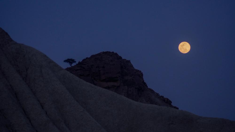 Full moon over a desert