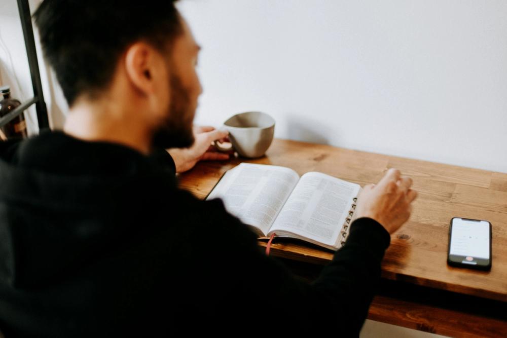 Man reading the bible at a desk