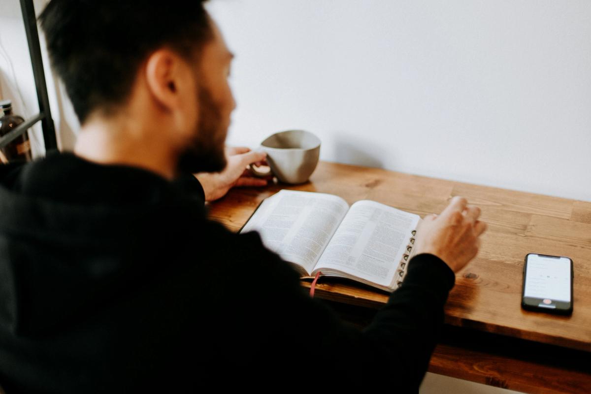Man reading the bible at a desk