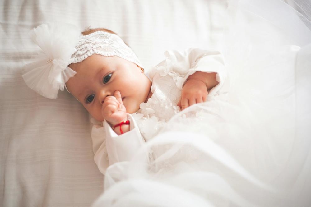 a baby dressed for their christening
