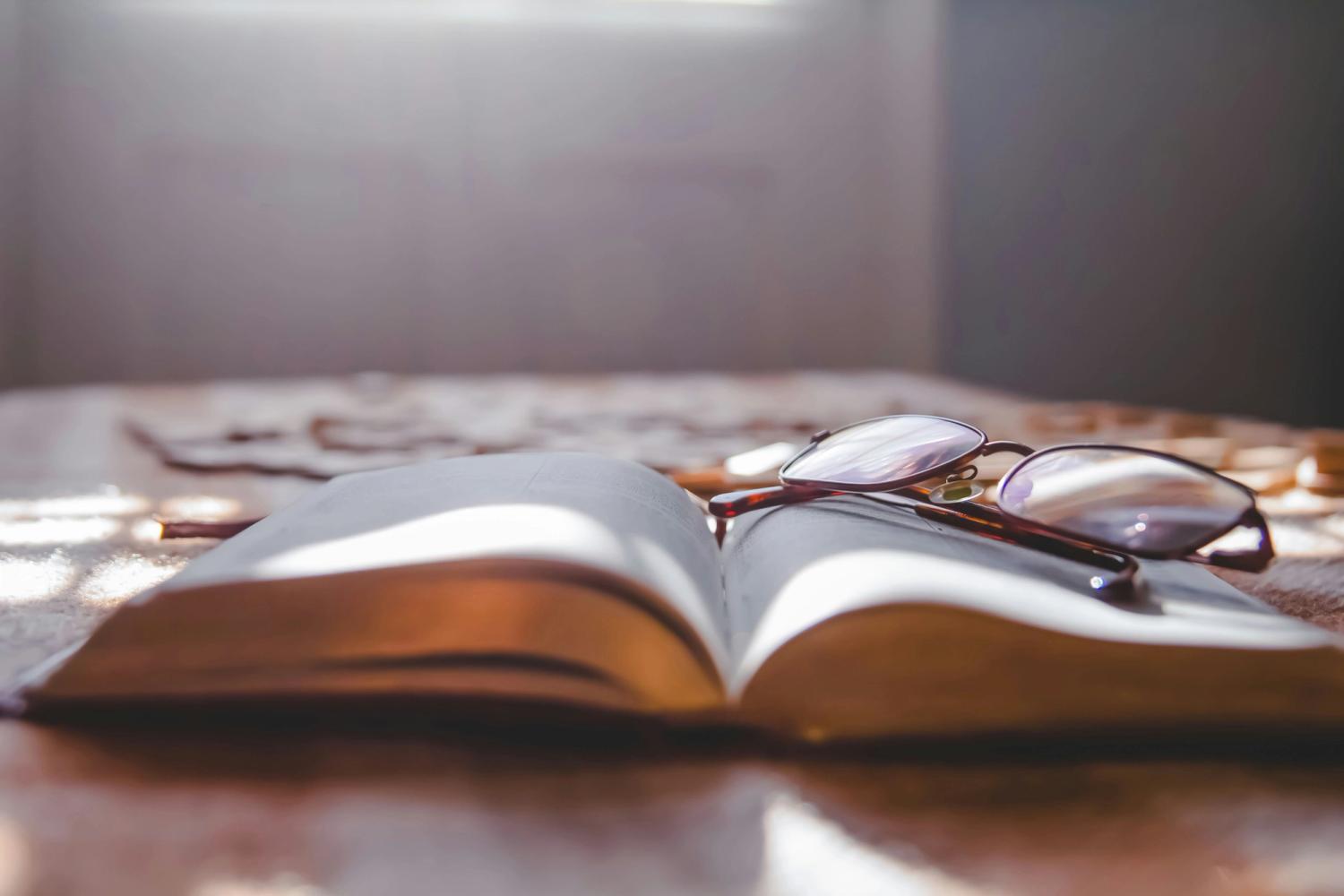 A Bible resting on glasses