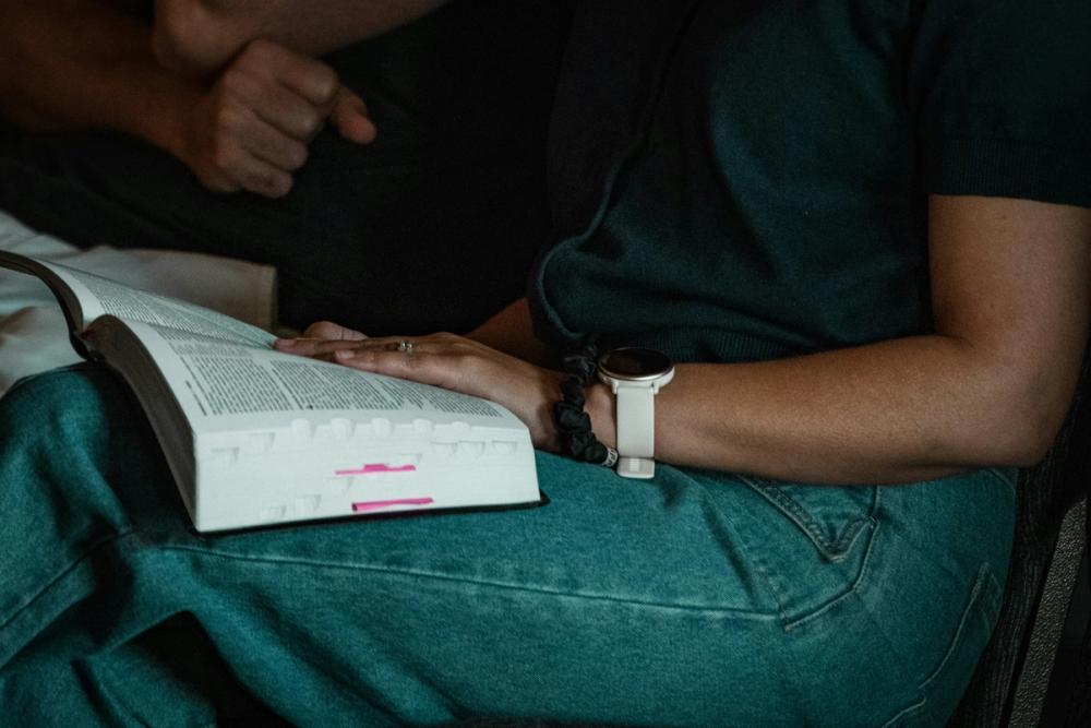 An open Bible on a lap