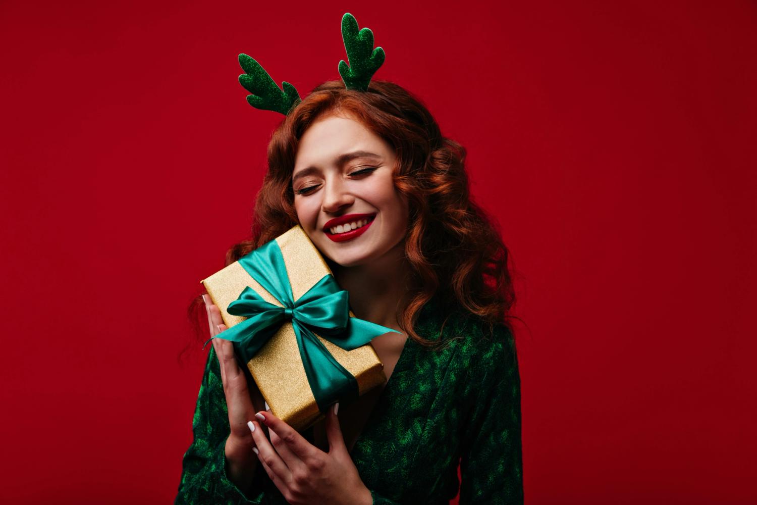 woman holding a christian christmas gift and smiling