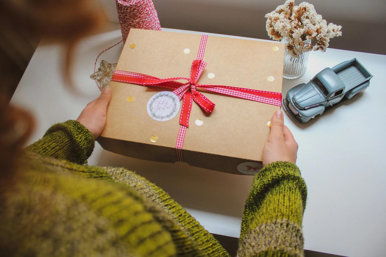 Someone holding a beautifully wrapped gift