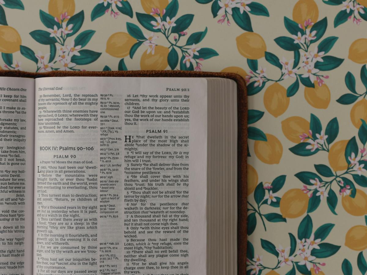 A Bible against a tablecloth with lemons