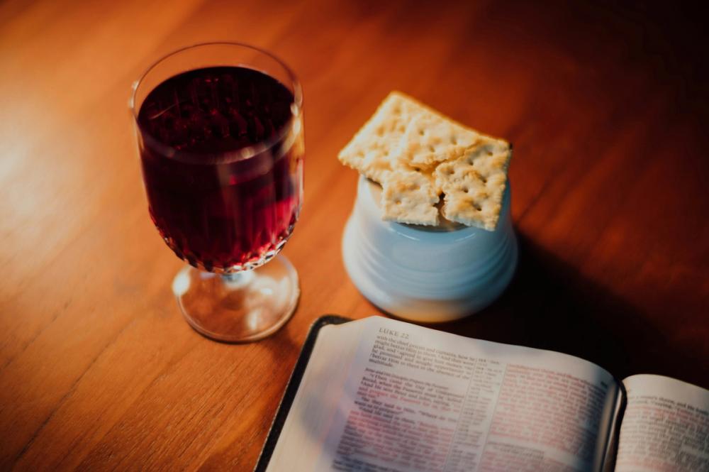 Communion wine and wafer and a Bible