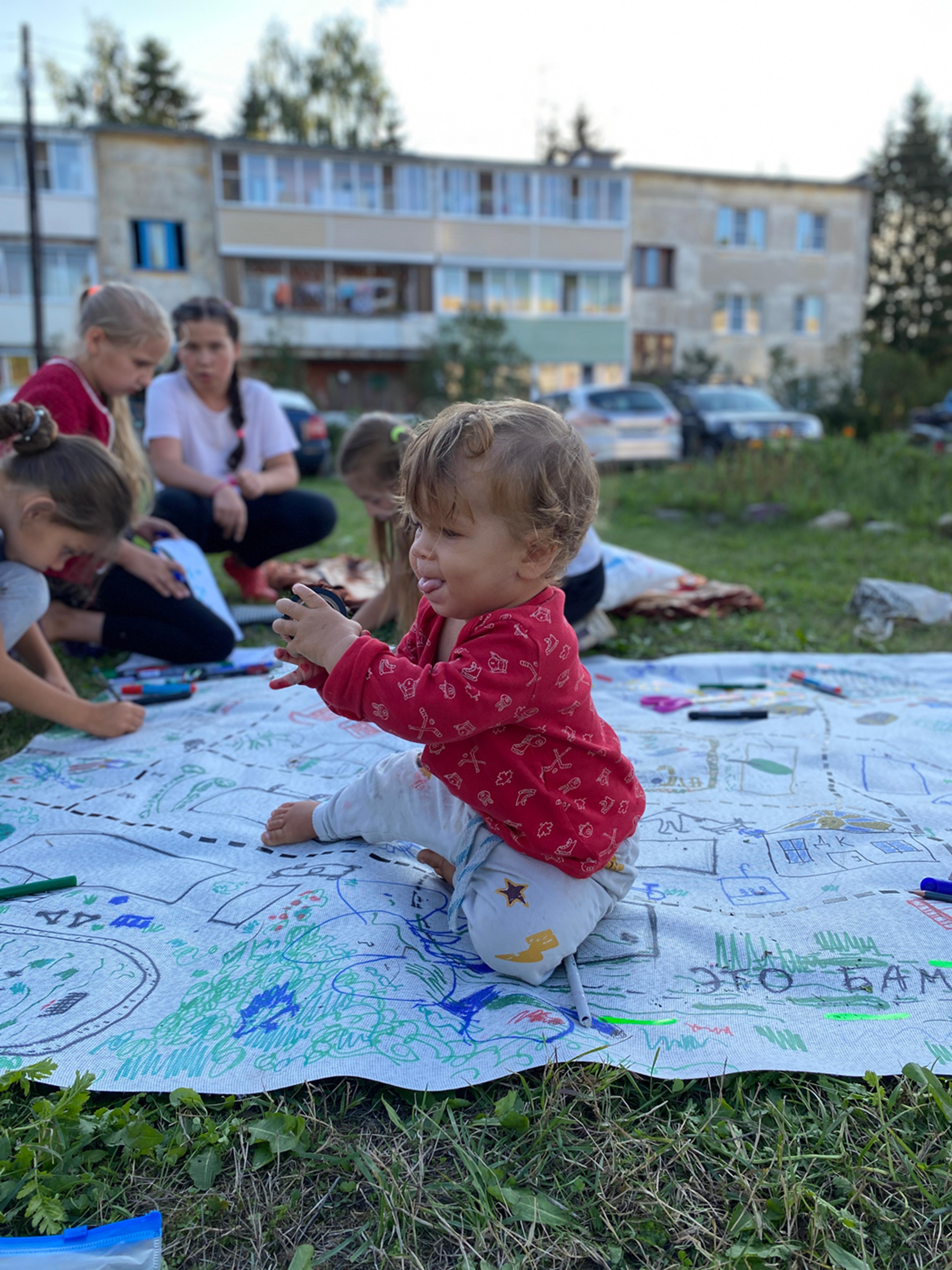 children making a map on the grass