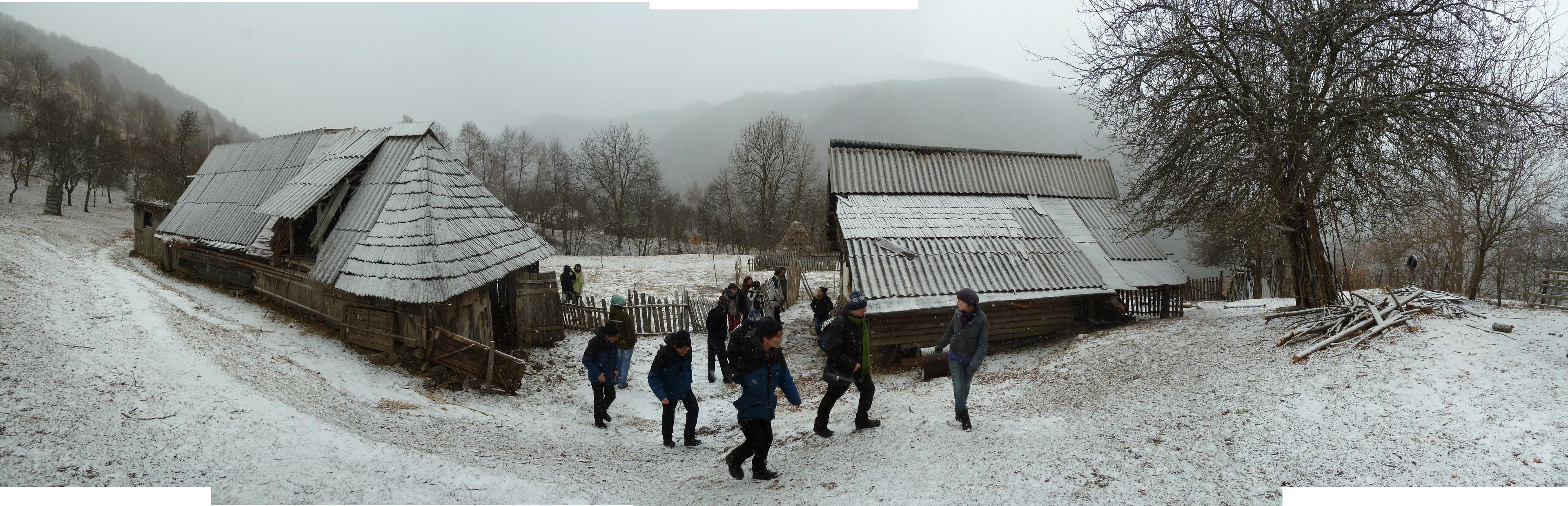 People walking outdoors in winter among country side houses