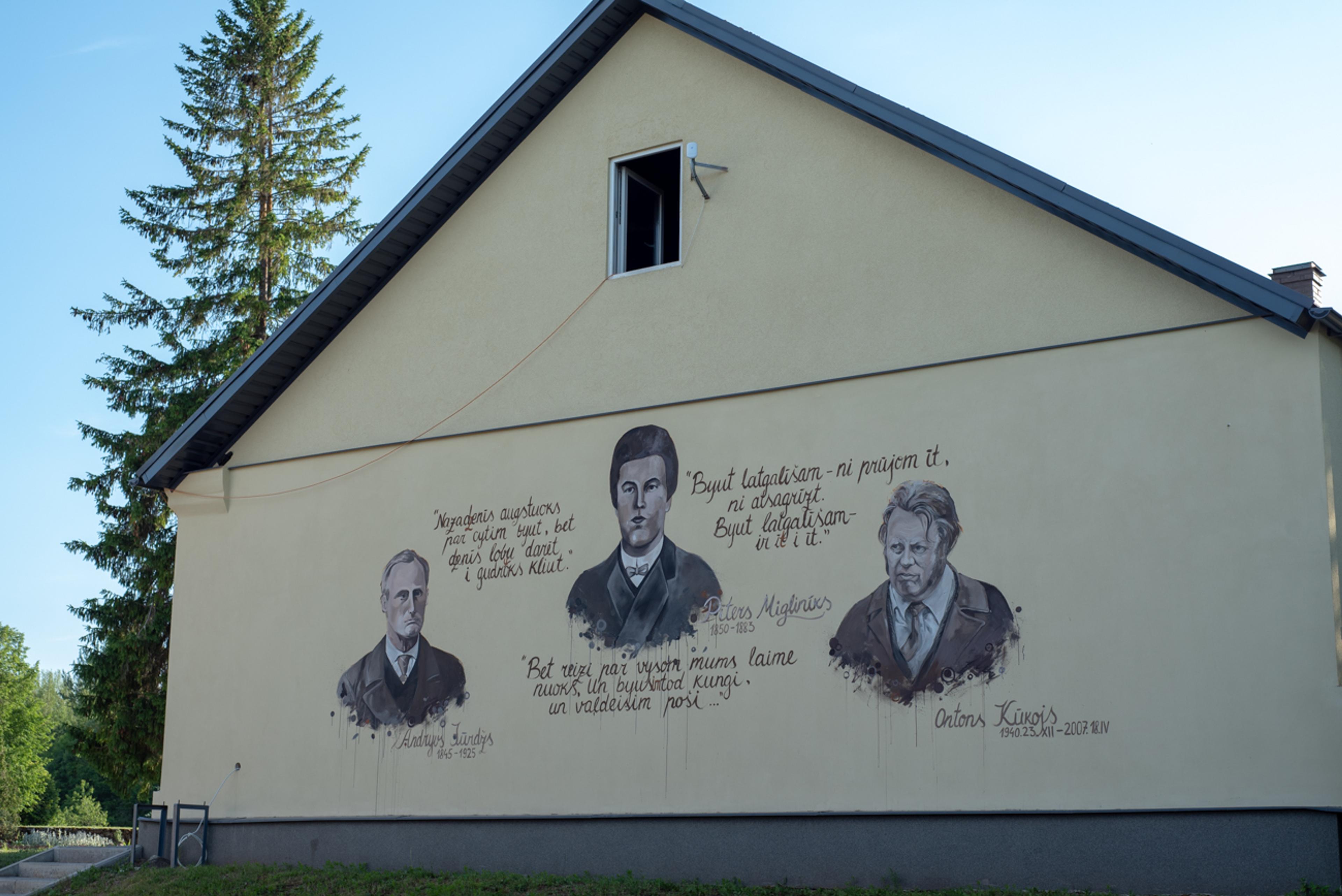 portraits of 3 men paintend on the wall