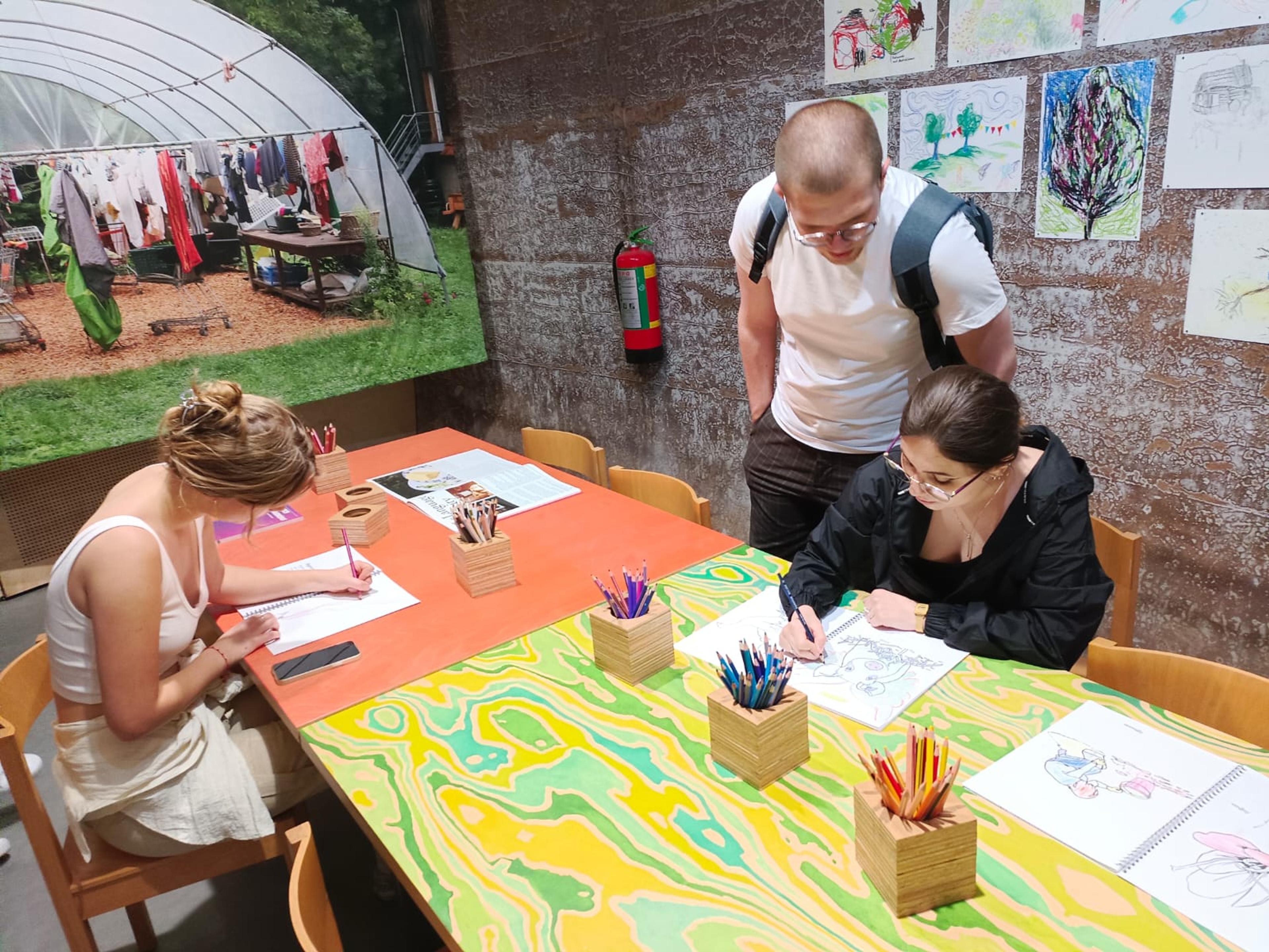 People drawing at an exhibtion