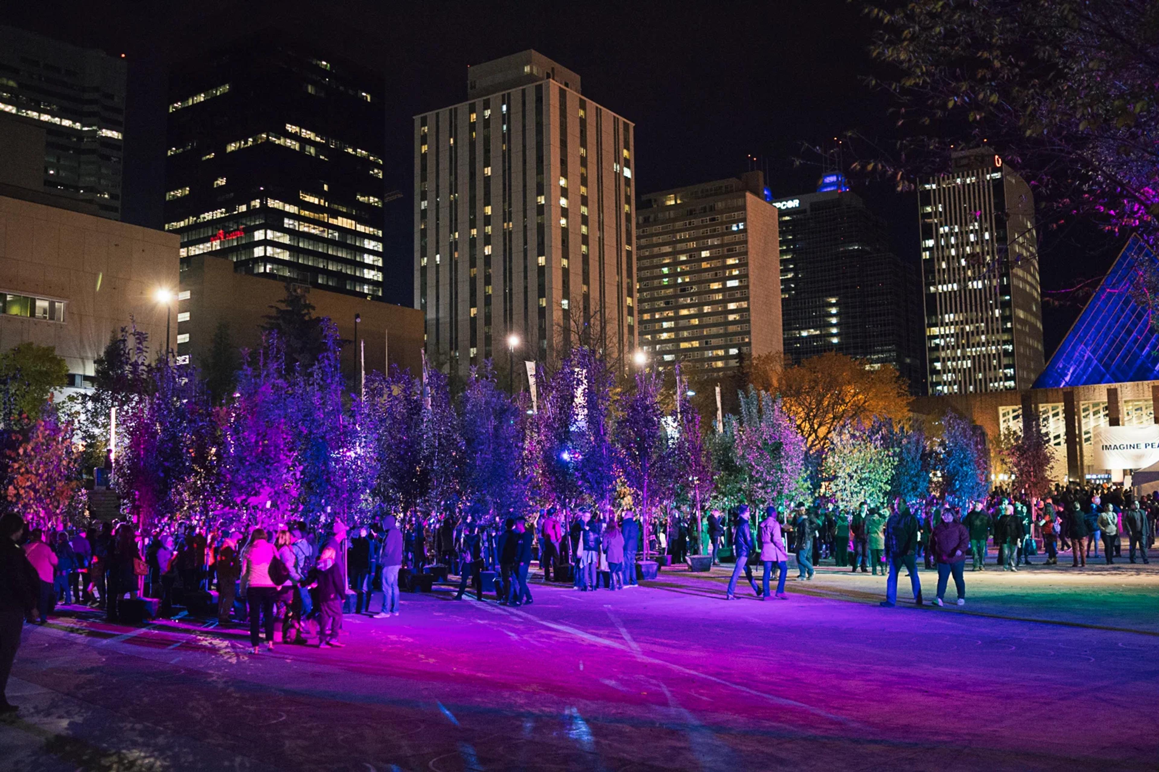downtown edmonton lit up at night with purple lights
