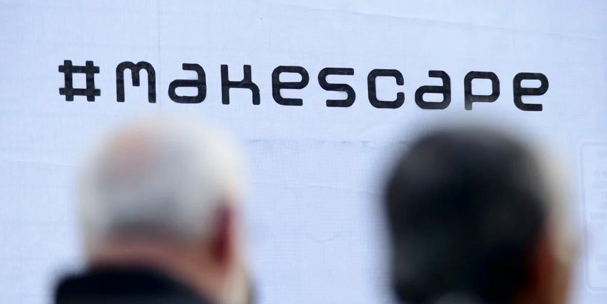 logo of the makespace brand with blurred people behind it