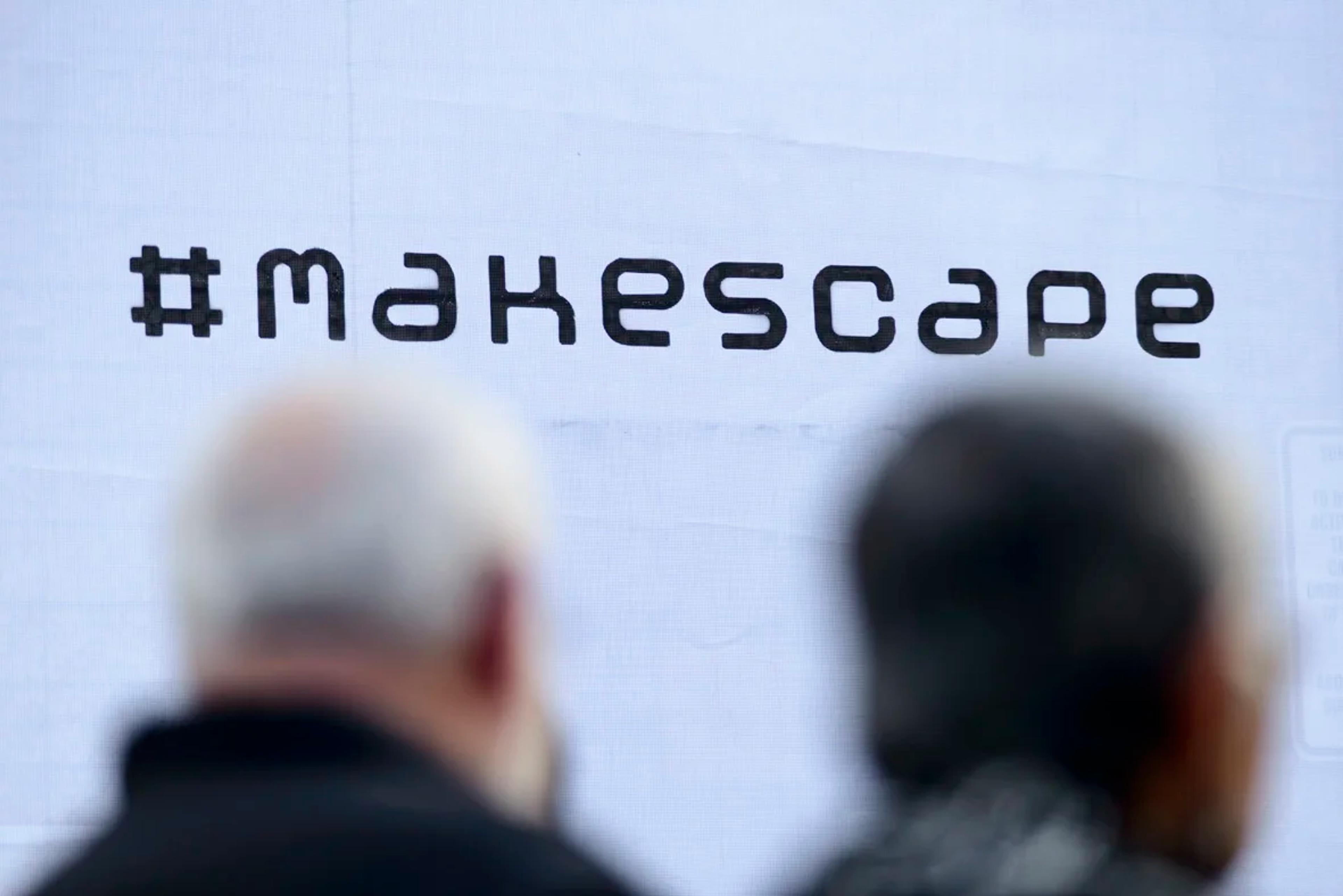 logo of the makespace brand with blurred people behind it