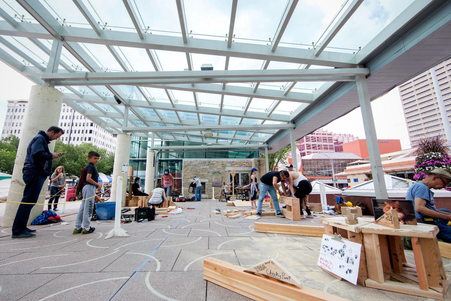 Group of people in Churchill Square Edmonton making furniture