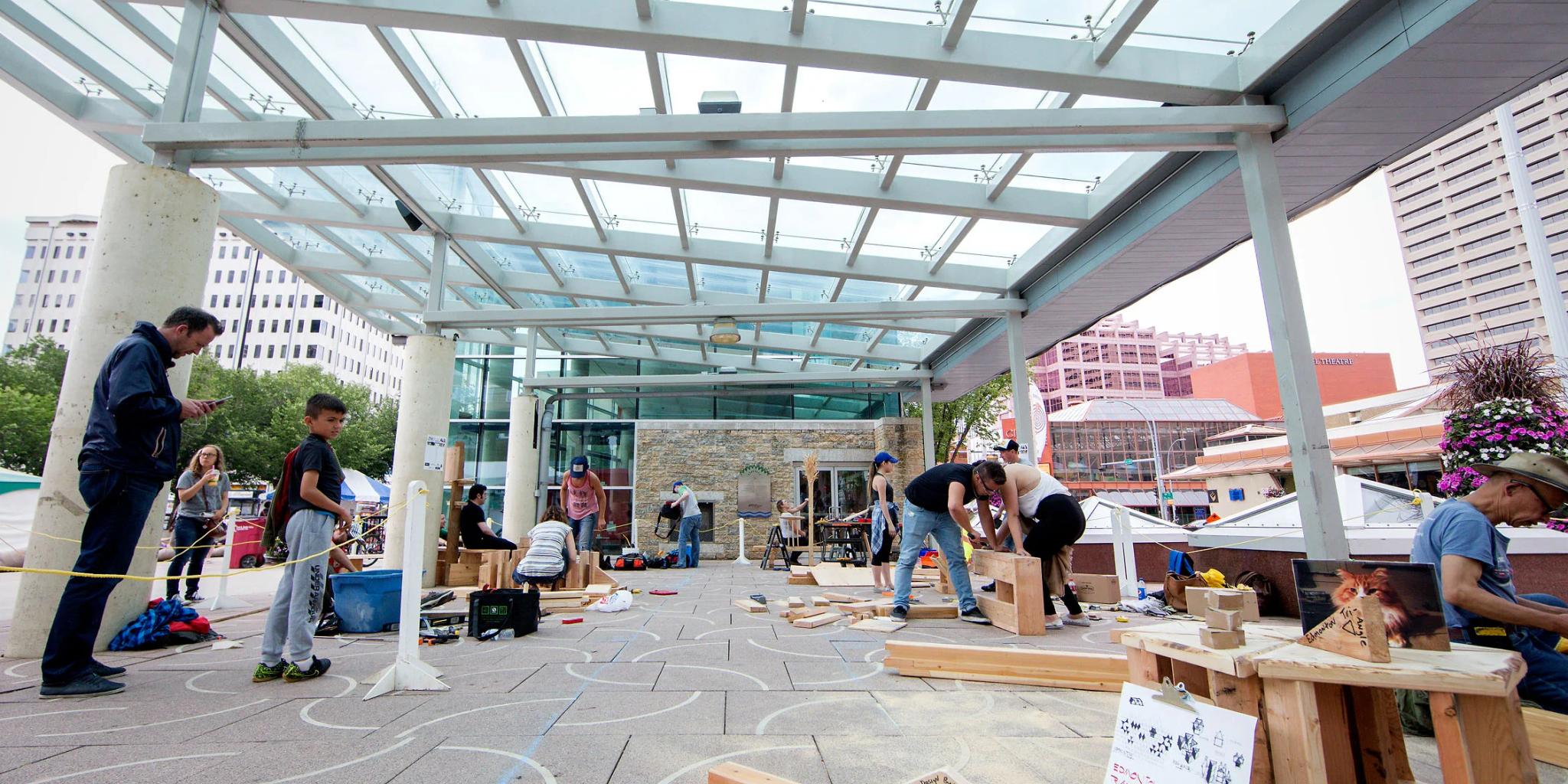 Group of people in Churchill Square Edmonton making furniture
