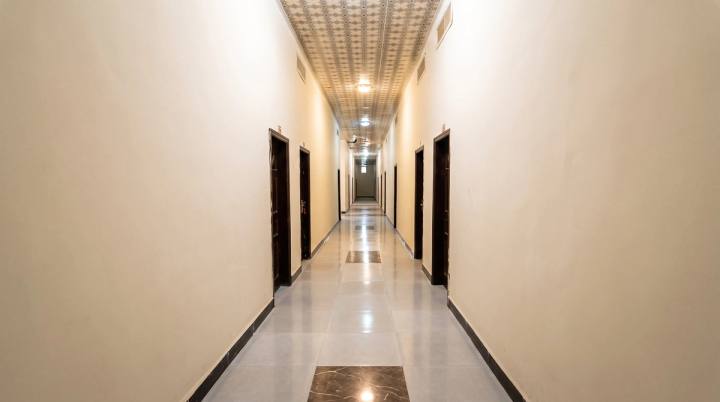 Corridor to the guest rooms with a tiled floor and patterned ceiling.
