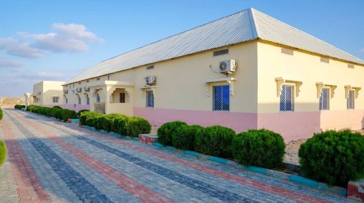 Iftin Hotel guest-room building with its paved path and trimmed shrubs.