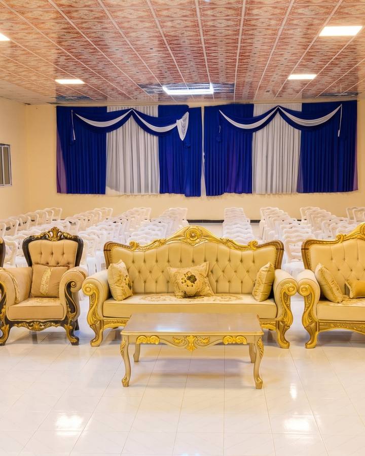 The event hall set with gold sofas for a wedding.