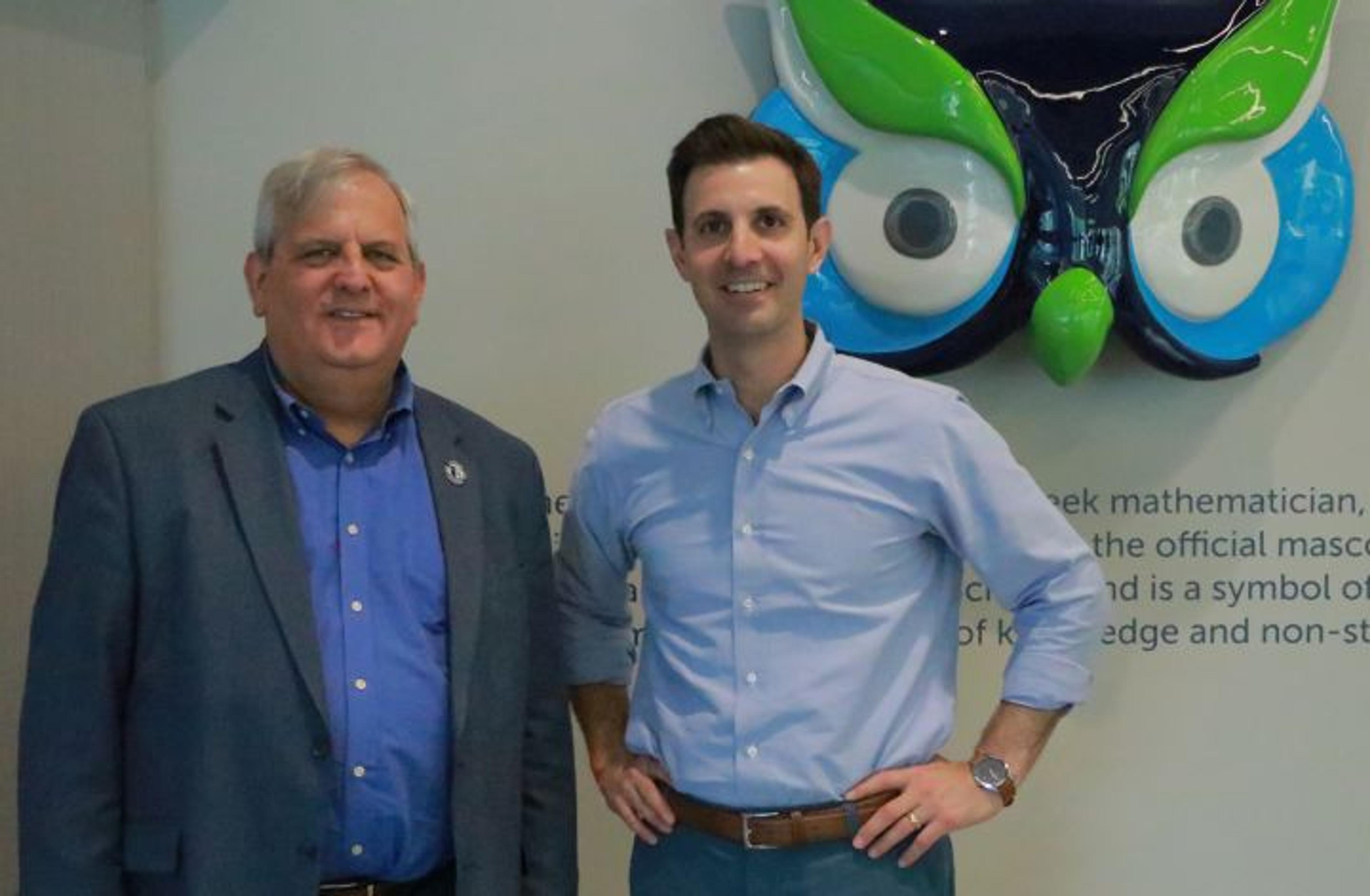 PA Cyber CEO Brian Hayden and Congressman Chris Deluzio stand in front of a statue of Archie the Owl