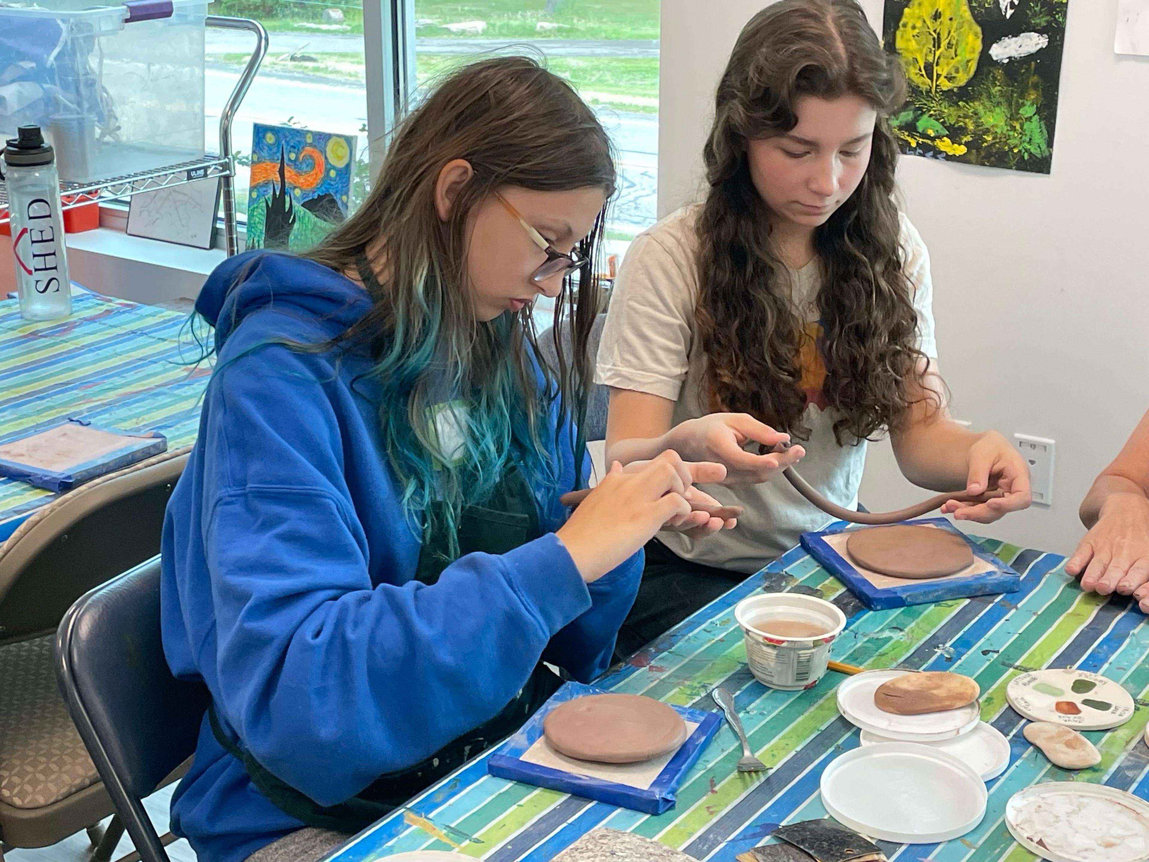 Students working with clay 