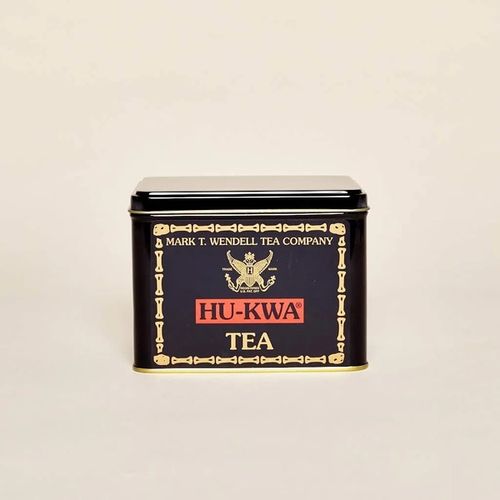 A tin box in black with gold and red details. Words read "Mark T. Wendell Tea Company" and "Hu-Kwa Tea