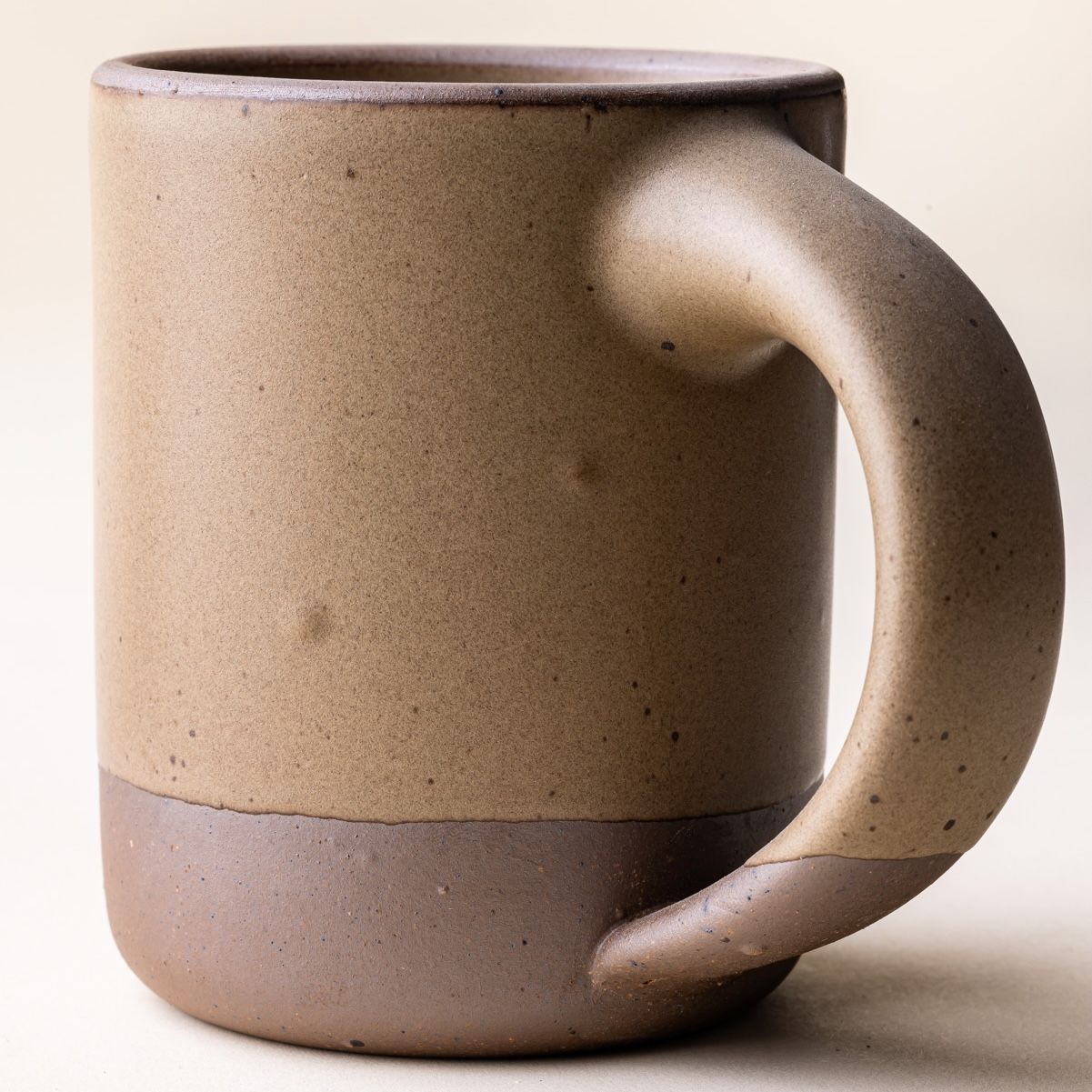 A ceramic mug has little bubbles underneath revealed on the glaze - also known as bloating.
