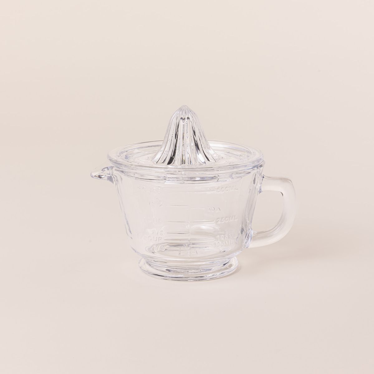 Traditional glass juicer with a handle and removable top