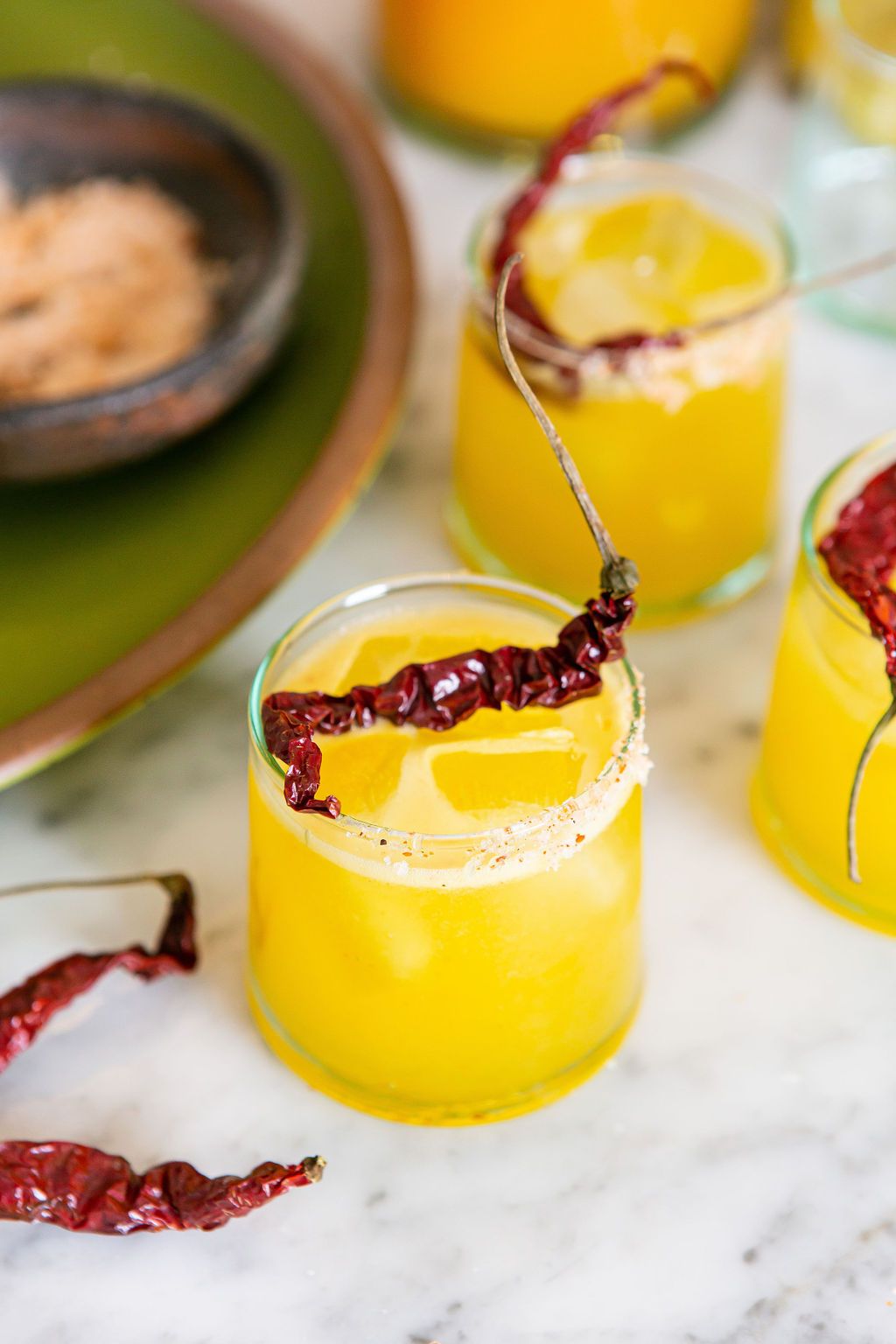 Saffron-infused cocktails topped with dried red chiles and rimmed with salt.