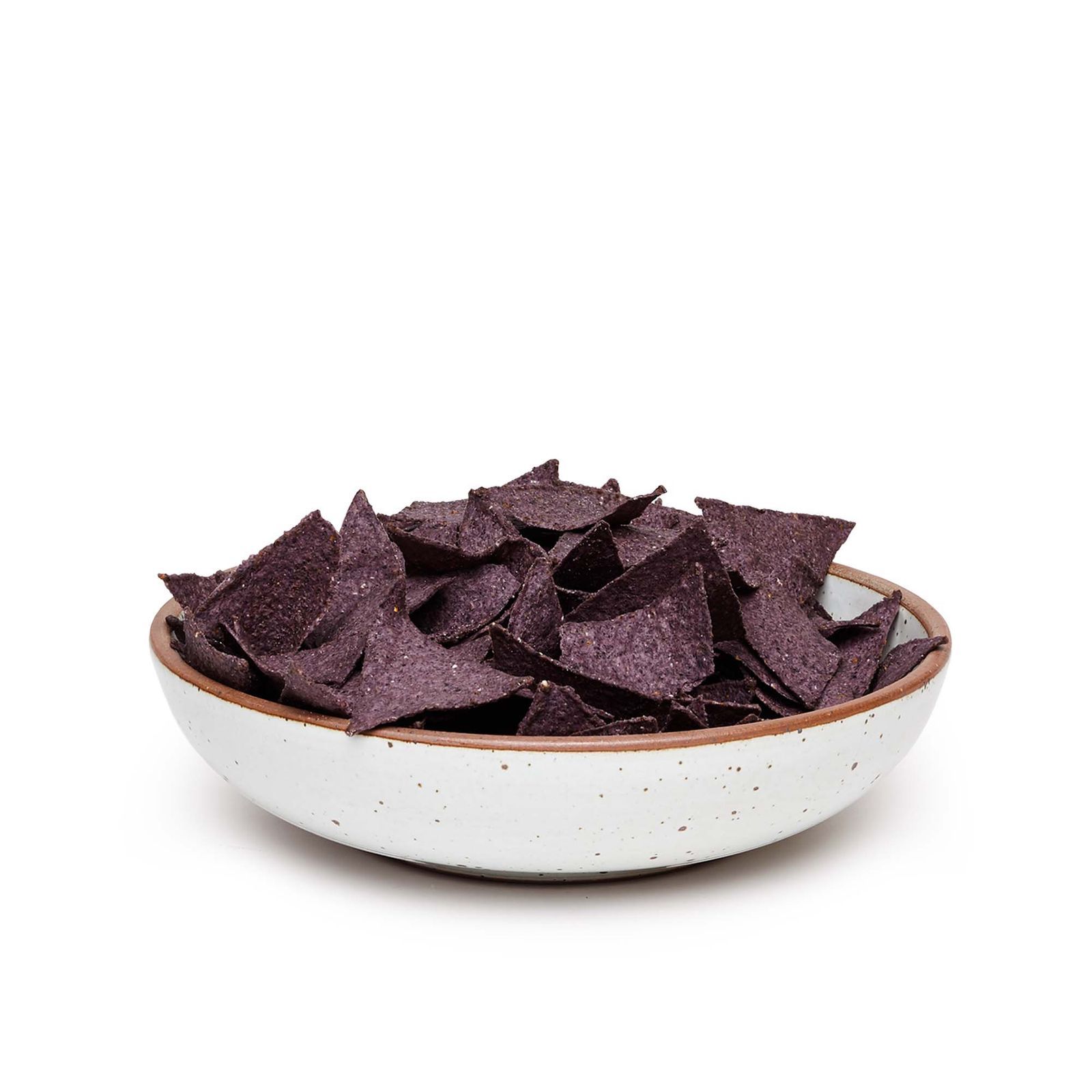An eggshell-white colored shallow, but large, bowl, filled with a heaping party-sized serving of black tortilla chips.