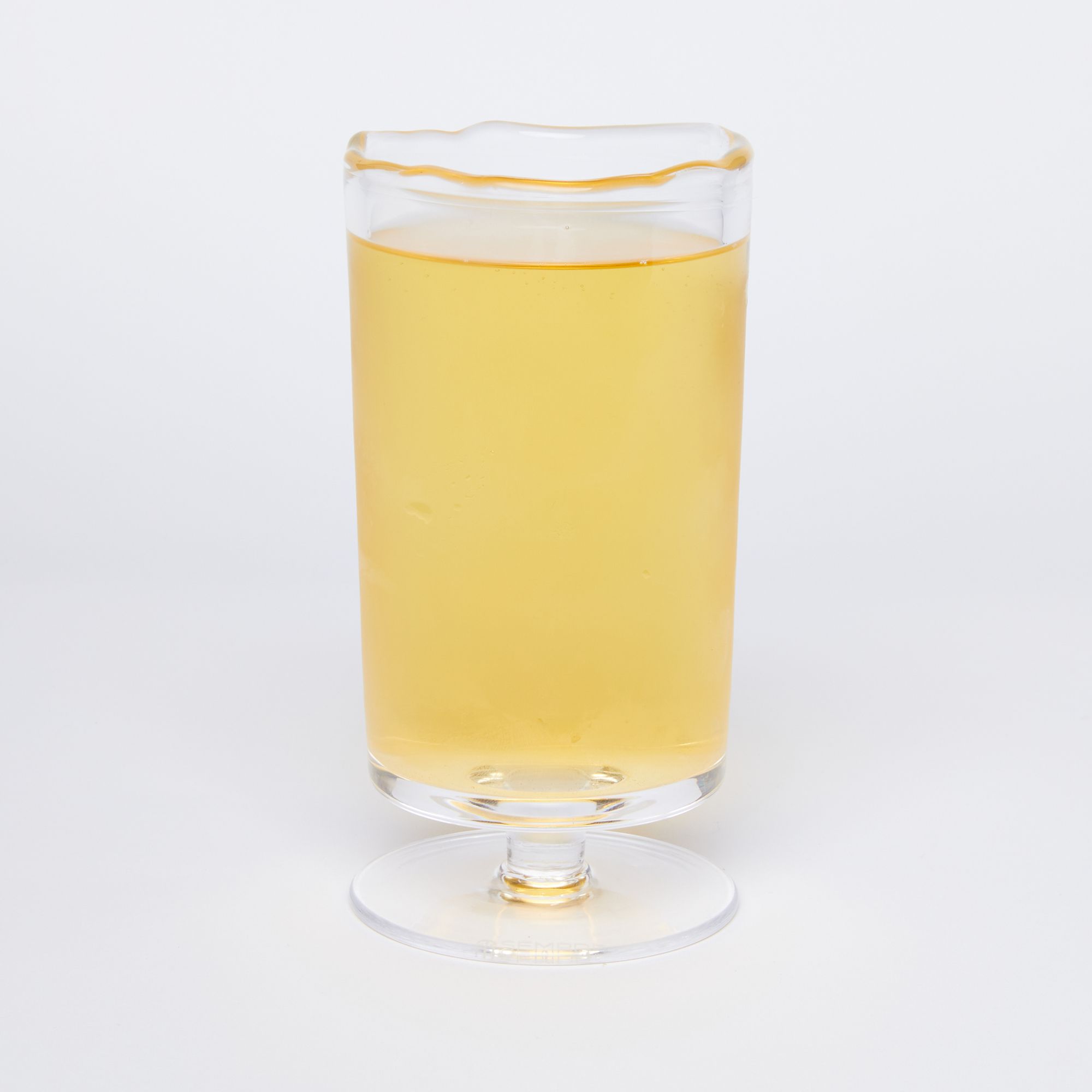 long bodied footed glass filled with beer