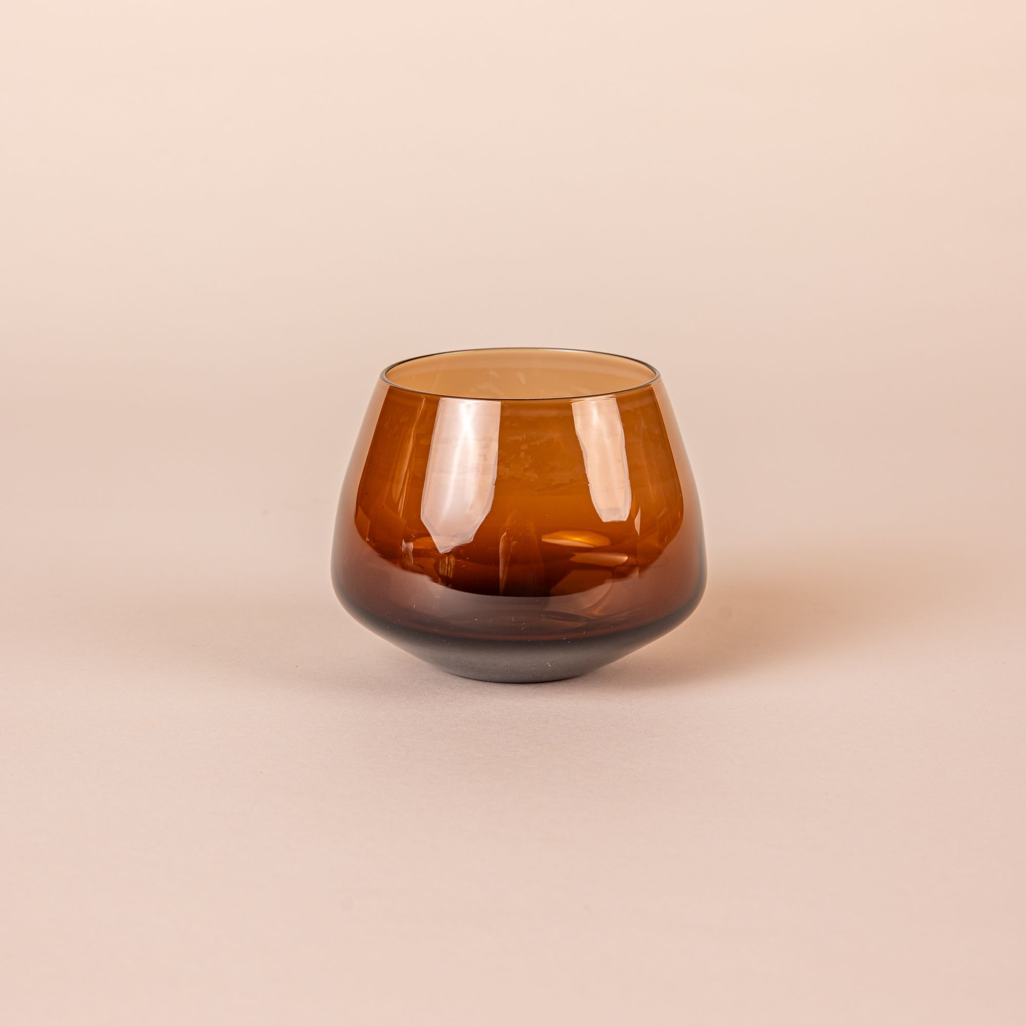 Brown glass whiskey snifter with a rounded base