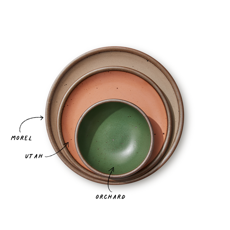 A stack of 3 plates in Dinner, Side, and Cake sizes in a warm pale brown, peach, and green colors.