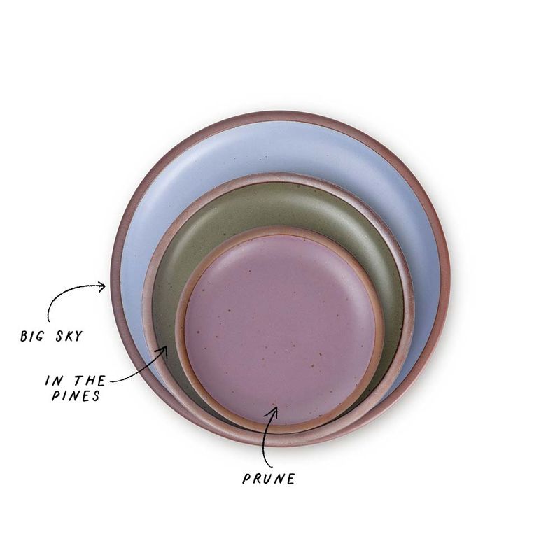 A stack of 3 plates in Dinner, Side, and Cake sizes in a periwinkle, muted forest green, and soft mauve purple colors.
