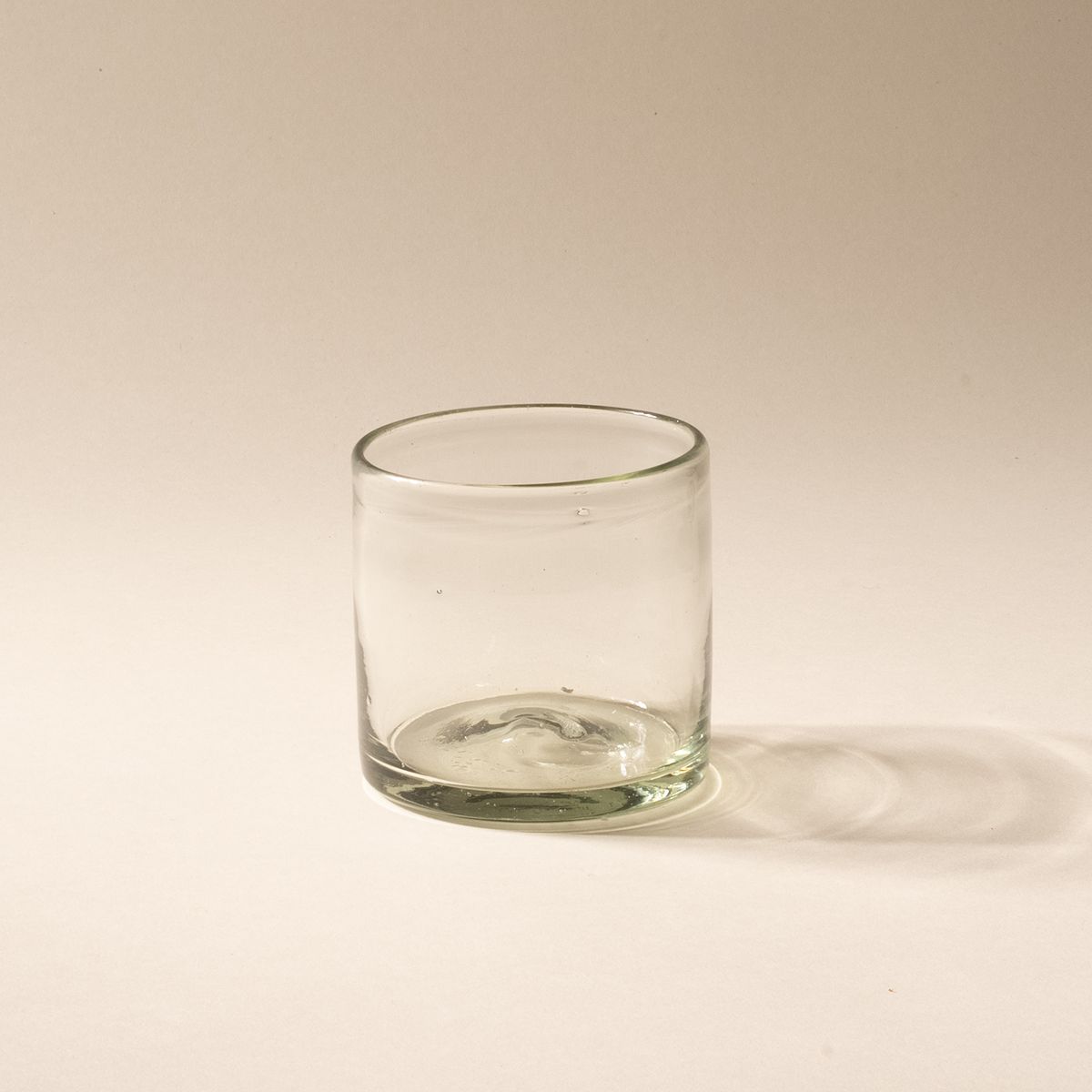 A short clear drinking glass