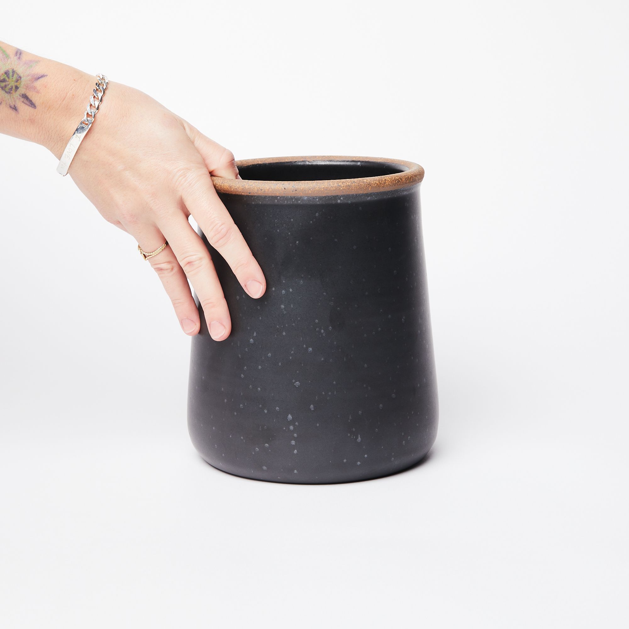 A cylindrical ceramic utensil crock in graphite charcoal color with an unglazed ridge rim.