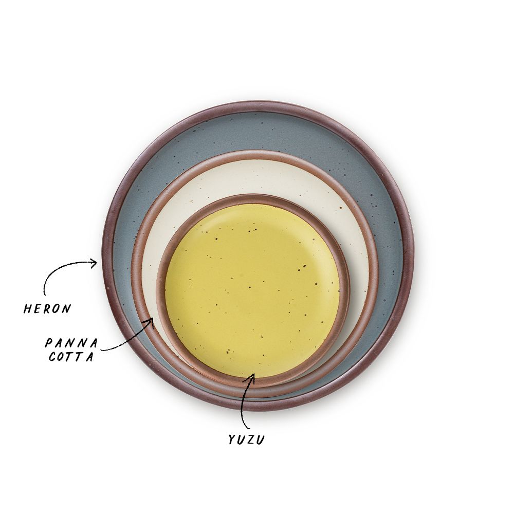 A stack of 3 plates in Dinner, Side, and Cake sizes in a blue-grey, warm off-white, and zesty yellow colors.