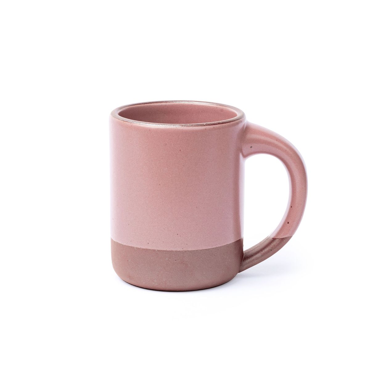 A big sized ceramic mug with handle in a dusty mauve pink color featuring iron speckles and unglazed rim and bottom base.