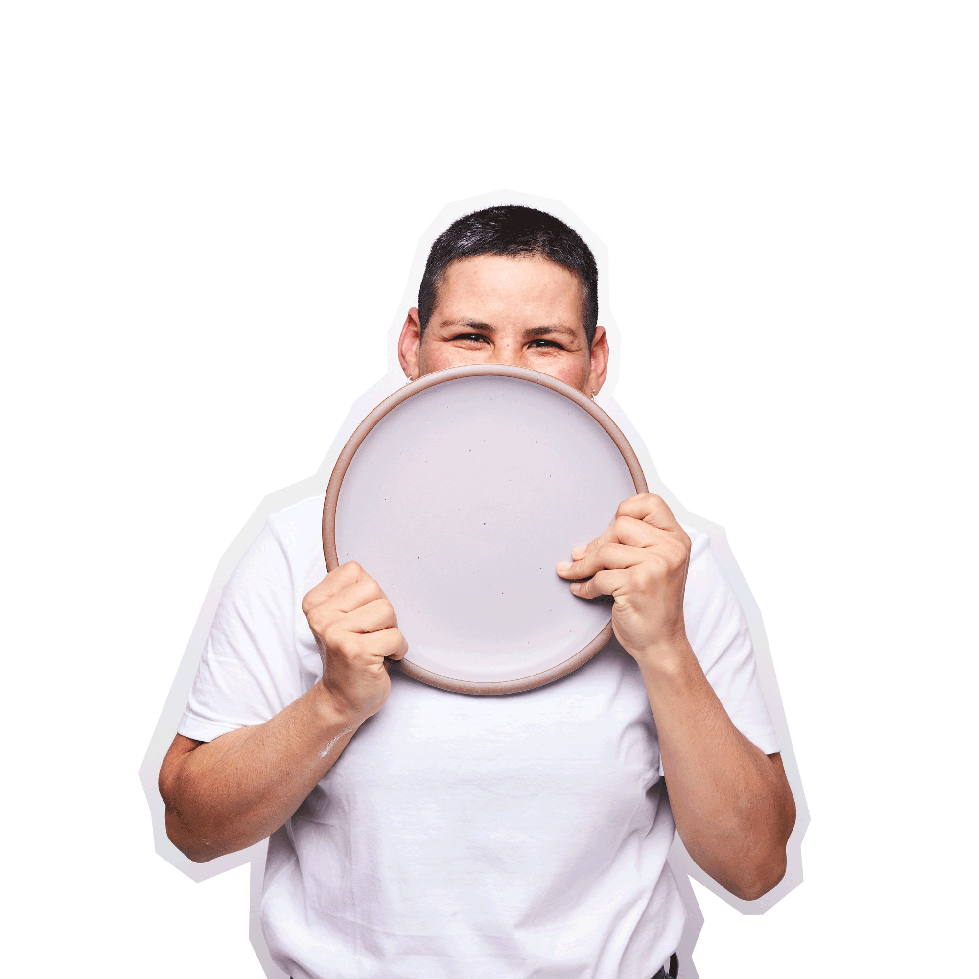 A person in a white t-shirt holds a large dinner plate in a pastel purple color
