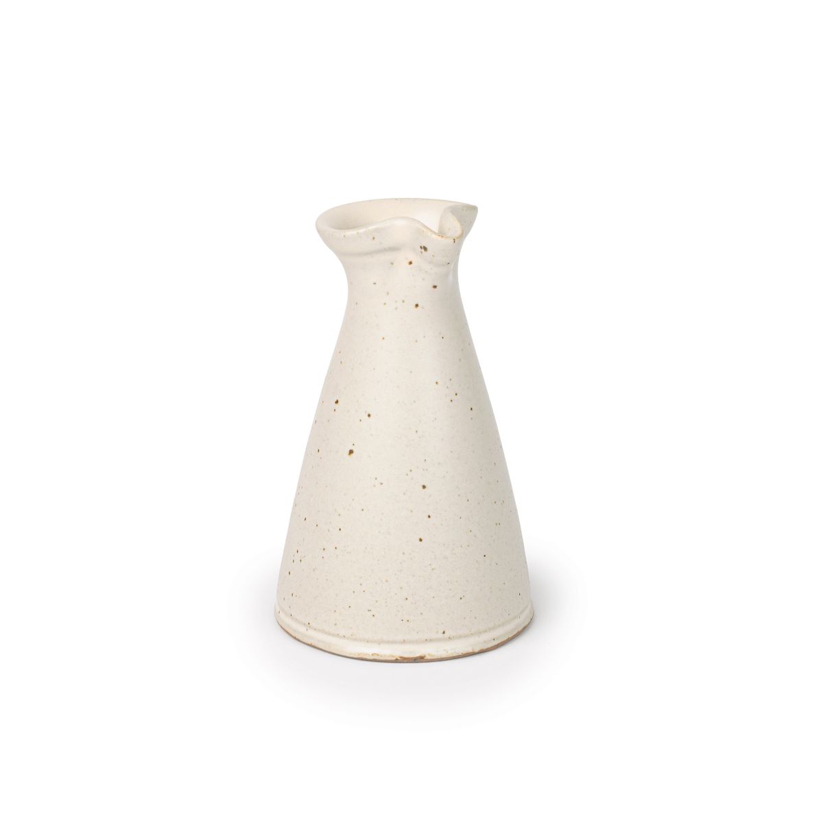 A small ceramic creamer with a narrow body and a subtle pouring spout at the top, in a warm off-white color, at an angle.